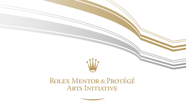  Rolex text Mentor and Protégé Arts Initiative text with silver and gold lines of different thickness  above