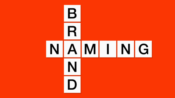 Red background with white scrabble square blocks moving to spell 'Brand Naming'