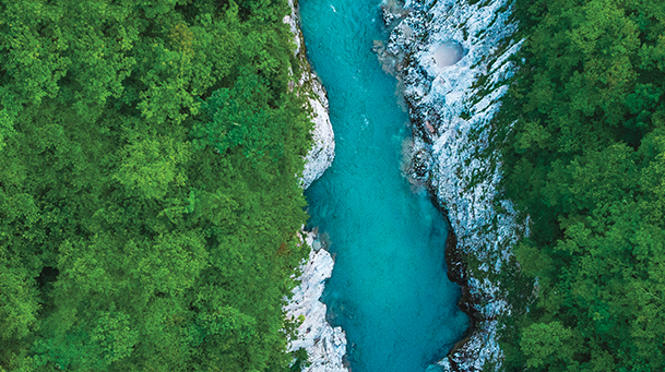 Aerial photo of a turquoise river and forest